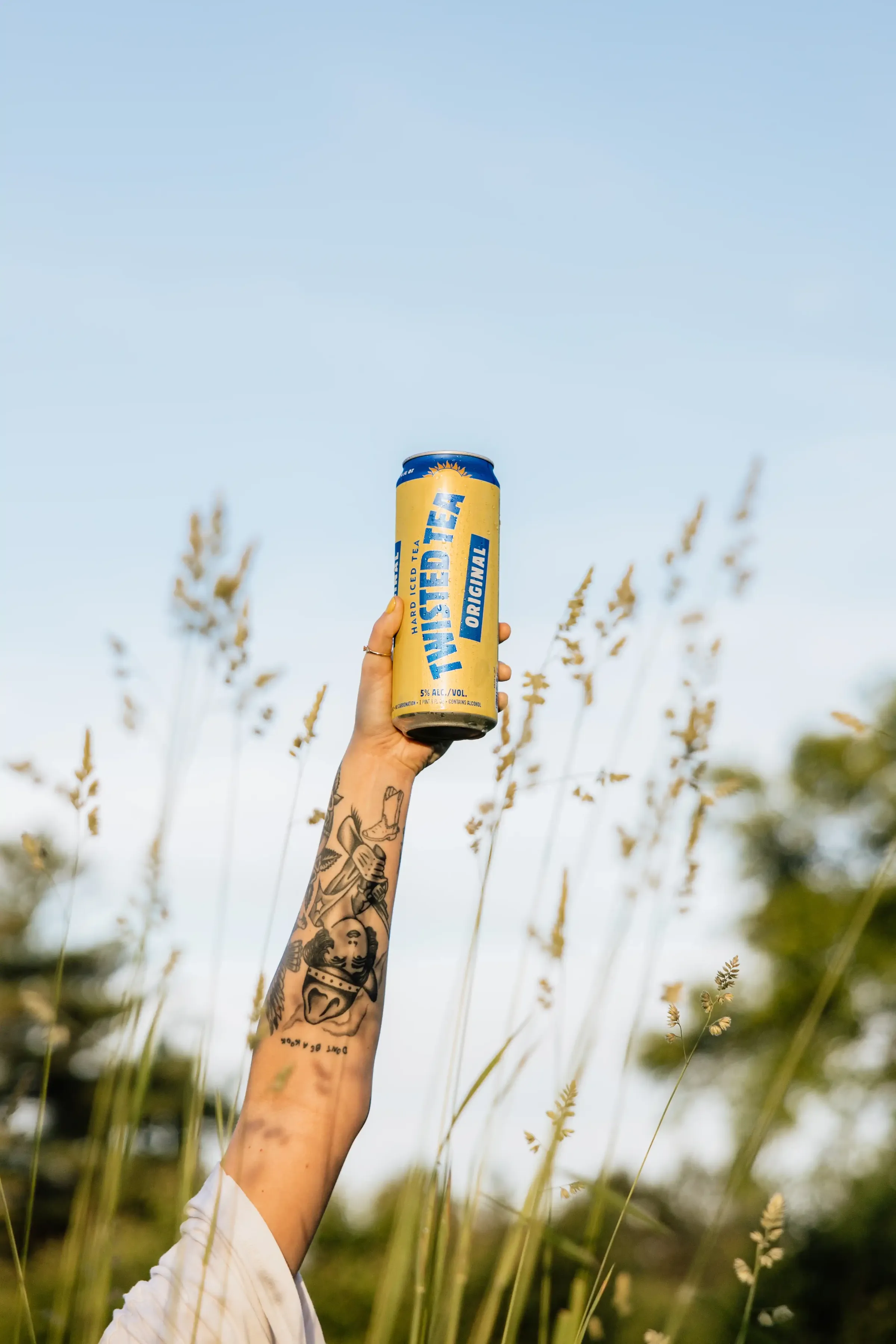 Can of Twisted Iced Tea held up in a field